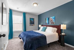 a blue bedroom with a large bed with blue walls at Hollywood Hideaway in Clarksville