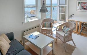 a living room with a couch and chairs and a table at Beautiful Apartment In Borre With House Sea View in Borre +10 photos
