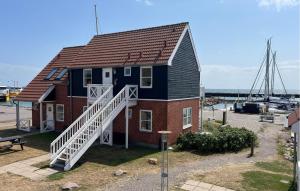 a small house with a staircase leading up to it at Beautiful Apartment In Borre With House Sea View in Borre