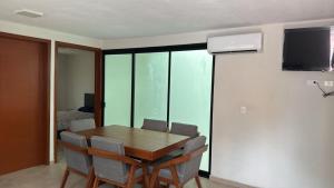 a dining room with a wooden table and chairs at Natura suite's & eventos in Guadalajara