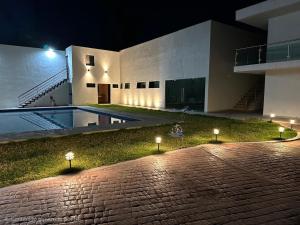 a building at night with lights in the yard at Natura suite's & eventos in Guadalajara