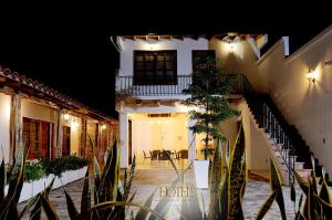 a building with a staircase leading to a patio at night at Hotel Madera y Tierra in Tame +11 photos