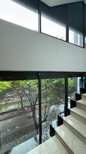 a large window in a building looking out at a tree at Sakura building hotel & restaurand in Hải Dương