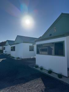 a row of houses in a parking lot at Bay Cottages in Kaikoura