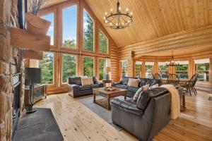 a living room with a couch and a fireplace at Fiddler Lake Resort - Deer 47 in Mille-Isles