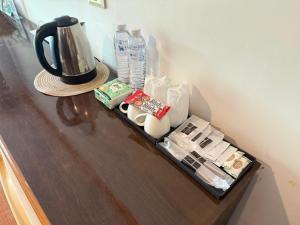 a shelf with a coffee maker and other items on it at Ban Mali Cafe & Riverside Stay in Ban Chang