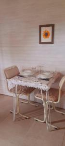 a table with plates and glasses on top of it at El Tropezon cabaña in Resistencia
