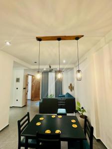 a living room with a table and a couch at The Elm in Weligama