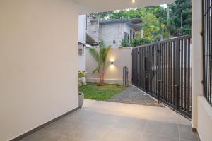 an entrance to a house with an iron gate at The Elm in Weligama
