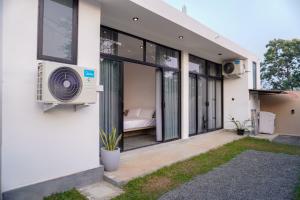 a house with a fan on the side of it at The Elm in Weligama +9 photos