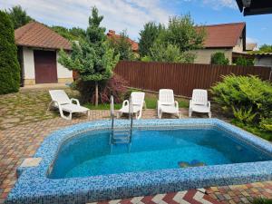 a small swimming pool with chairs at Outbreak 3 bedroom house with outdoor pool, BBQ and dining in Pirita in Corjova