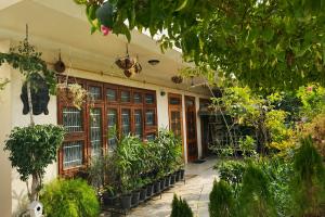 a building with a bunch of plants in front of it at SoulStay Vrindavan in Mathura