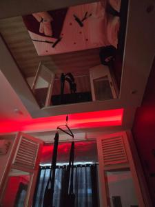 a room with red lights and a ceiling with umbrellas at Love Room Owfeah in Pointe-à-Pitre
