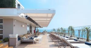 a row of tables and chairs on the balcony of a building at SOUMA Hotel, Vignette Collection by IHG in Lima