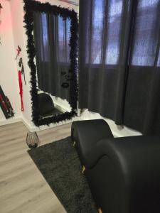 a living room with a couch and a mirror at Love Room Owfeah in Pointe-à-Pitre +2 photos