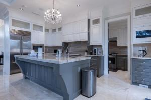 a large kitchen with white cabinets and a large island at Private Room in Richmond in Richmond