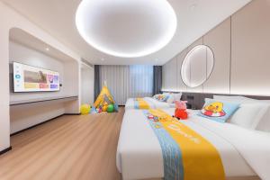a bedroom with two beds and a flat screen tv at BOLE ZHEYU Hotel in Bole