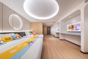 a hotel room with two beds and a tv at BOLE ZHEYU Hotel in Bole