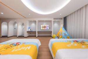 a bedroom with two beds and a birthday party at BOLE ZHEYU Hotel in Bole