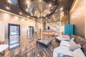 a living room with a couch and a table at BOLE ZHEYU Hotel in Bole +73 photos