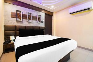 a bedroom with a large white bed in a room at Townhouse Hirak Road Dhanbad in Dhanbād +13 photos