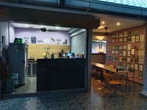 a kitchen and a dining room with a table at OCEAN LODGE in Pantai Cenang