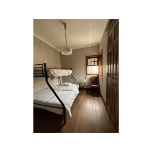 a bedroom with a bed and a window at Casa Quixote, Centro Catedral in Braga