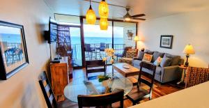 a living room with a glass table and a couch at Check In, Chill Out - Annies Surf Shack Awaits! in Kahana