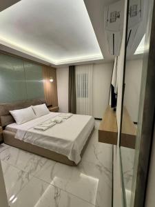 a hotel room with a bed and a glass window at Ydora Luxury Hotel in Bodrum City +18 photos