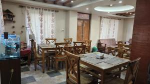a dining room with wooden tables and chairs at Kathmandu Metro Boutique Hotel in Kathmandu