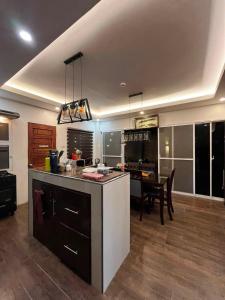 a kitchen with a table and a dining room at DonnRaqui's Hidden Zen in Iligan