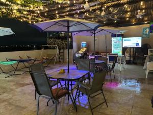 a group of tables with umbrellas in a room at Hostel HA LUXURY in Cartagena de Indias