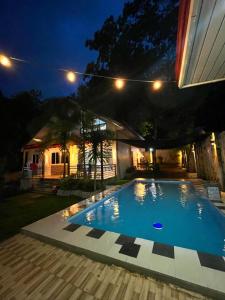 a swimming pool in a backyard at night at DonnRaqui's Hidden Zen in Iligan