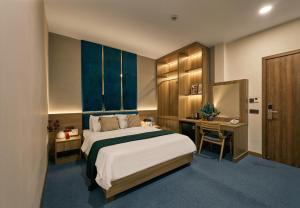 a hotel room with a bed and a desk at Tran Long Hotel By Urban B in Ho Chi Minh City