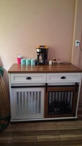 a counter with a coffee maker on top of it at Villa La Patrona in Parrita
