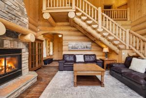 a living room with a couch and a fireplace at Fiddler Lake Resort - Bear 25 in Mille-Isles