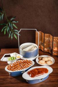 a table with plates of food and a box of food at Kerry Hotel, Beijing by Shangri-La in Beijing