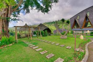 a garden with a gazebo and a house at Plaga Eco Village by Nabe Hospitality Management in Plaga