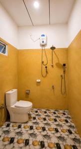 a bathroom with a toilet and a shower at Sinharaja Forest Lodge - Deniyaya in Dombagoda