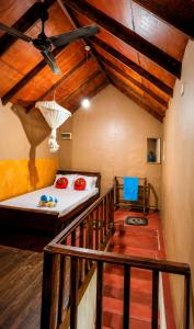 a room with a bed and a staircase in a house at Sinharaja Forest Lodge - Deniyaya in Dombagoda