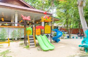 a playground with a slide in front of a house at Baan Kiao in Haad Yao