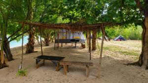 a camp site with a bench and a tent at Vatudei Homestay - Yasawa Islands in Somosomo