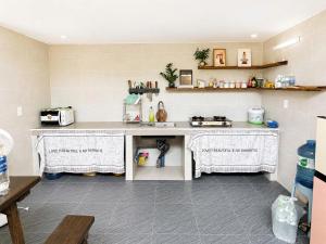 a kitchen with a counter and a counter top at Machy Home in Phú Quốc