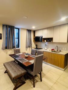 a kitchen with a table and chairs and a kitchen with a counter at Refugio urbano Saori in Guadalajara