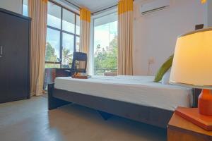 a bedroom with a large bed and a large window at Tranquil Heaven Near Galle & Unawatuna Quiet Stay & Fast WiFi in Galle