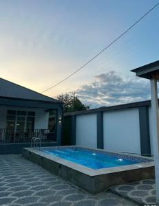 a swimming pool in the backyard of a house at Rewad villa in Gabala