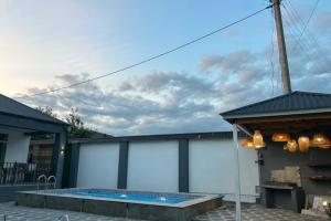 a patio with a swimming pool next to a building at Rewad villa in Gabala