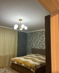 a bedroom with a bed and a ceiling at Rewad villa in Gabala