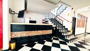 a lobby with a staircase and a checkered floor at Hotel Beijing Cartagena in Cartagena de Indias