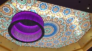 a purple plate on top of a mosaic wall at Hotel Granada Palace, Affiliated by Melia in Monachil +50 photos